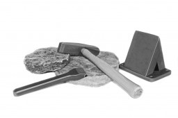 A set of masonry thin stone tools including a hammer chisel and wedge used for trimming thin stone