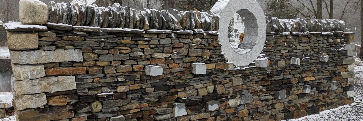 Elaborate stone wall made up of different colored stones